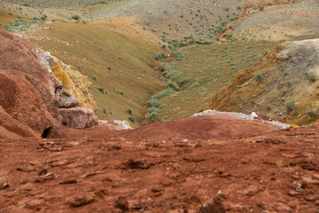 Red sandy slopes of canyon. Corrosion the soil after drought and global warming. Lack of water in stone desert