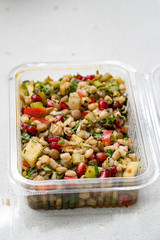 Instant Take Away Healthy Salad with Wheat, Lentil, Pomegranate Seeds, Pickles and Pear Slices in Plastic Box / Package Container.