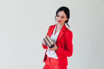 Naklejka premium Portrait of a beautiful business woman brunette with in a red business suit