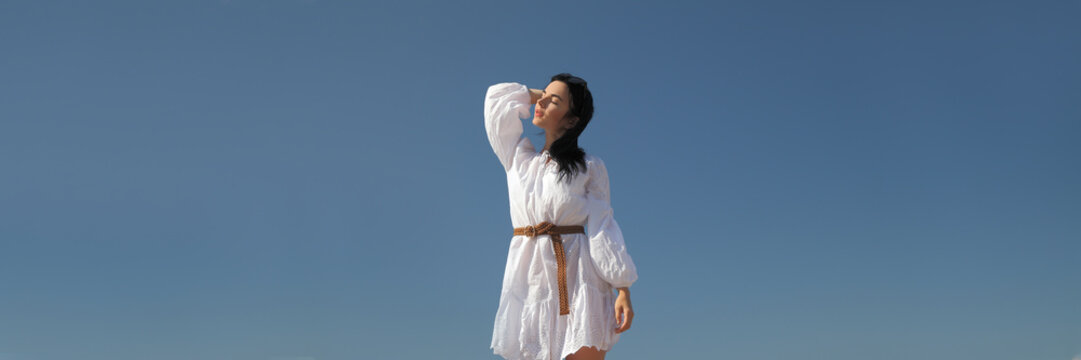 Young Happy Girl In A White Dress By The Sea