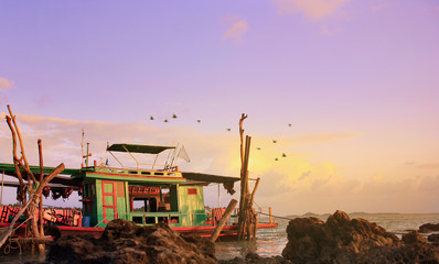 Tour boat by a beach in a peaceful evening , Surat Thani , Thailand