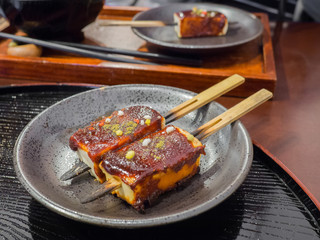 Tofu with sauce and sprinkled with colorful sugar is Japanese street foods