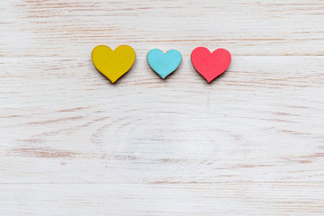 Wooden hearts on wooden background. Top view with copy space