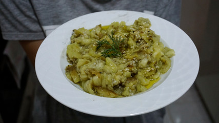 Roasted eggplant salad on plate. Traditional appetizer which have been eaten with raki.