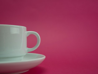Selective focus of white cup on pink background, isolated.Copy space.Quotes concept.