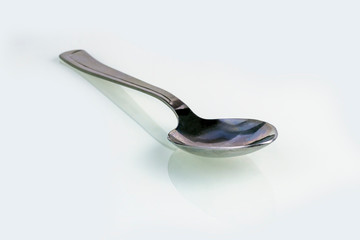 close-up. empty steel spoon on a white background. insulation.