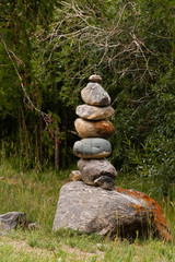 Fototapeta na wymiar Slide of stones for orientation in forest. Hiking in mountains. Meditation, state of balance of soul. Yoga classes in nature