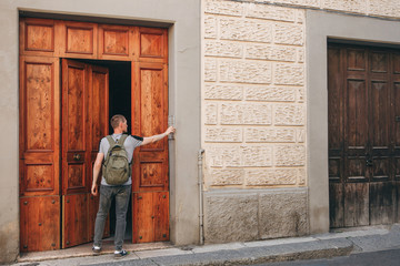 A tourist or student calls the intercom for access inside the house.