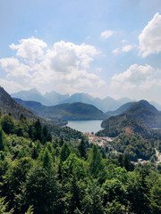 Fototapeta na wymiar Misty day in the Bavarian Alps near Fussen, Germany. Alps and lakes in a summer day in Germany. Taken from the hill next to Neuschwanstein castle. View of the Hohenschwangau castle, Bavarian Alps