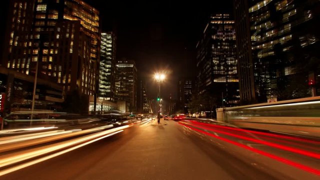 Avenida Paulista night traffic dancing pulsating crazy buildings expensive real estate Sao Paulo Brazil. Loopable seamless animation cinemagraph