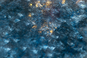 Deep blue with gold splashes over concrete.