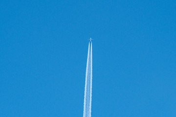 trail of plane flying in blue sky
