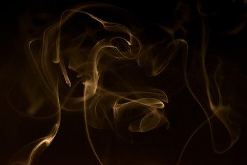 Gold smoke abstract on black background, fire design and darkness concept