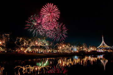 Fototapeta premium Multicolored bright festive fireworks in the dark sky background.Beautiful colorful fireworks for celebration holiday concept. 