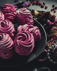 Handmade air russian fruit pink marshmallow on a black background. Homemade Sweets.