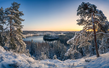Scenic snow landscape with blue clear sky and beautiful sunset at mood winter morning in Finland