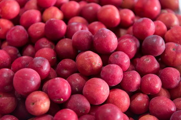 Plum stacked in the sale of a food market in Colombia.