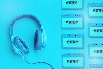 Turquoise headphones a colored background. Music concept with copyspace. Blue headphones isolated