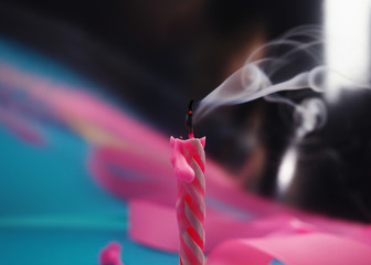 Extinguished candle with smoke trailing off the wick