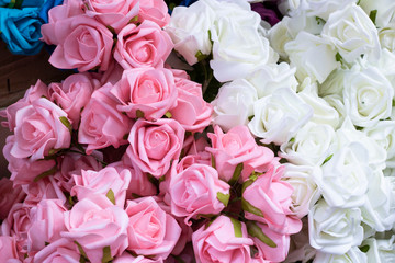 Pink and white fake roses. Made of textile material.