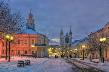 Street of the old European city at dusk, early winter morning.