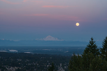 Full moon near Mount Baker during Fraser Valley sunset