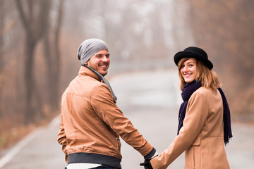 Fototapeta premium Couple enjoying outdoors in cold autumn / winter time.