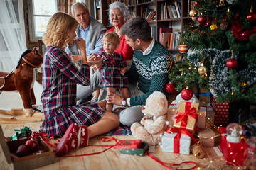 Fototapeta na wymiar Little blonde toddler girl excited about Christmas morning