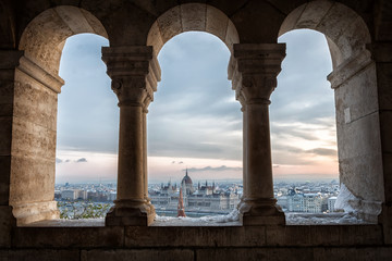 Fototapeta premium Panoramic view of Budapest through the windows of the Fisherman's Bastion at dawn in winter