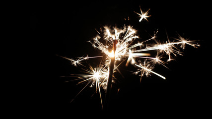 Close-up of firework sparkler burning. Fireworks burn on a black background