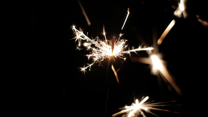 Close-up of firework sparkler burning. Fireworks burn on a black background