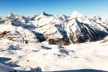 Fototapeta na wymiar Panorama with snowy mountains, blue sky. Alps.