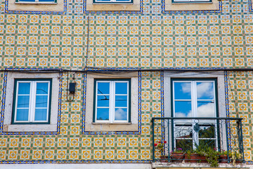 Fototapeta na wymiar Traditional architecture of the facades covered with ceramic tiles called azulejos in the city of Lisbon in Portugal
