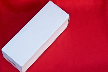 White cardboard box on trend color lush lava 2020