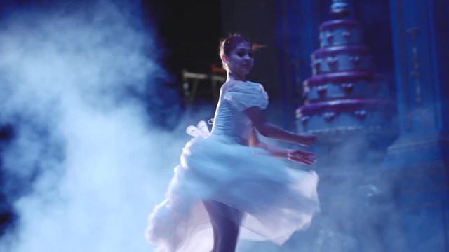 Classic ballet ballerina dancing on stage on Pointe