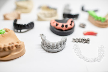 Various of artificial jaw models with dental implants and crowns on the white background. Concept of aesthetic dentistry and implantation technology