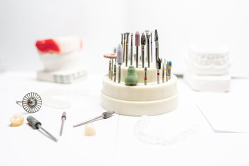 Set of dental technician burs and working instruments for implants and gypsum jaws manufacturing on the white background