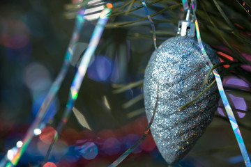 Christmas tree cone silver color on a decorated Christmas tree. Christmas backgroung