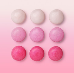 Group gradient pink drops candies isolated on pink background
