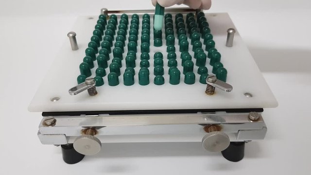 Preparation of capsules using a manual machine