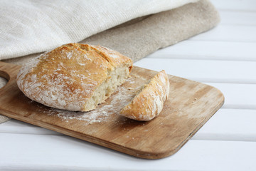 slice of ciabatta on a cutting board. fresh breakfast bread