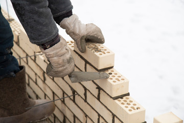 Laying bricks. Making a brick wall.Construction of a brick house.