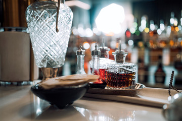 Bottles with different alcoholic drinks on the bar counter