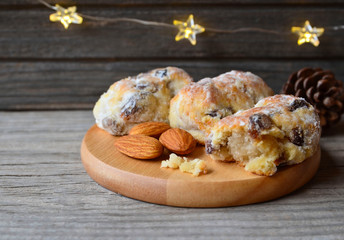 Traditional German,Swiss and Austrian Christmas pastry mini stollen cakes with dried fruit,nuts and spices on a rustic table.Winter festive baking concept.Selective focus.