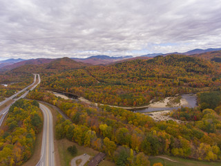 Interstate Highway 93 at Exit 30 with US Route 3 and Pemigewasset River in White Mountain National Forest aerial view with fall foliage, Town of Thornton, New Hampshire NH, USA.