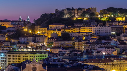 Lisbon aerial cityscape skyline night to day timelapse from viewpoint of St. Peter of Alcantara, Portugal