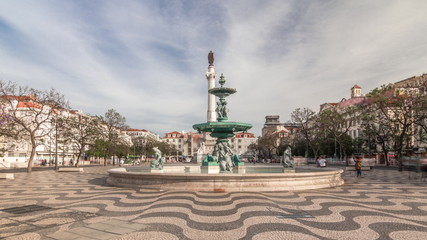 Fototapeta na wymiar Rossio square with fountain and monument on column located at Baixa district timelapse hyperlapse in Lisbon, Portugal