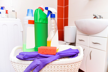 Set of plastic bottles, a sponge and rubber gloves for cleaning in the toilet, shower and bathroom.