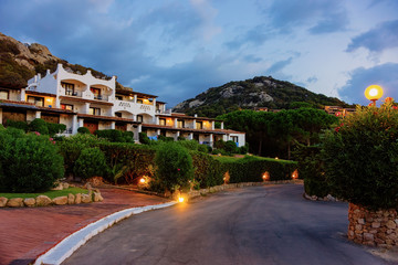 Fototapeta na wymiar Houses at Baja Sardinia luxury resort at night on Sardinia