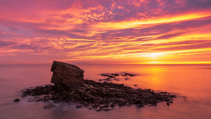 Sunrise at Charlies Garden, a rock stack at Collywell Bay, Seaton Sluice, Northumberland, England, UK.